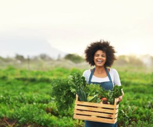 Cropped portrait of an attractive young female farmer carrying a crate of fresh produce